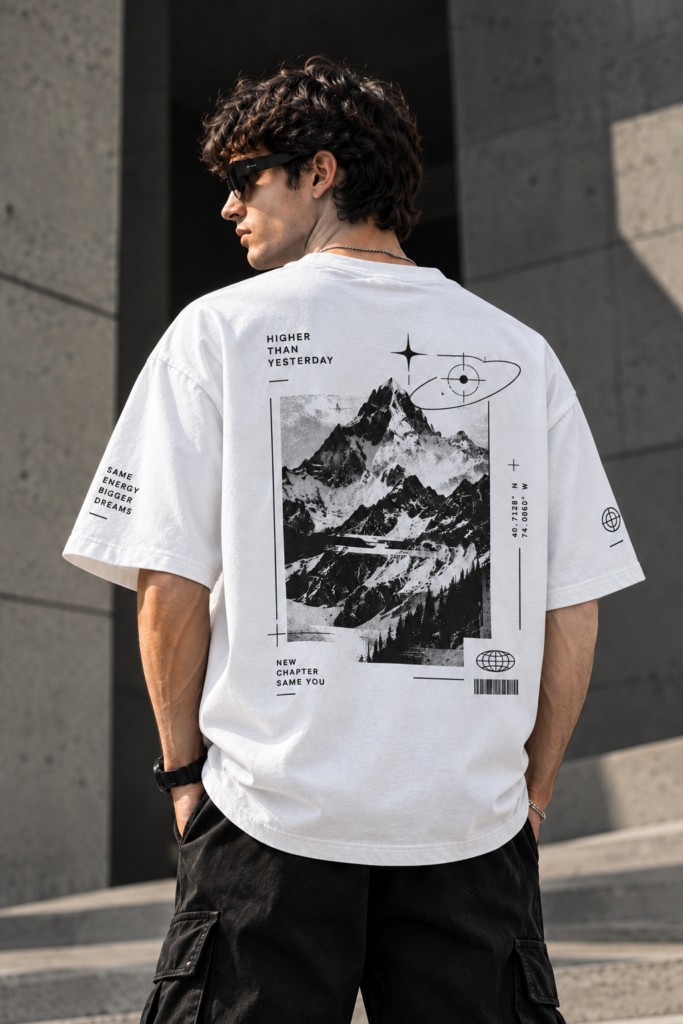 Model wearing the white INFONORAY Higher Than Yesterday oversized T-shirt, showing its mountain and orbital back design